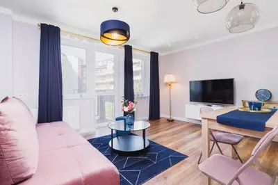 a living room with a couch and a tv at Apartament przy Bulwarach Wiślanych Kościuszki by Noclegi Renters in Kraków
