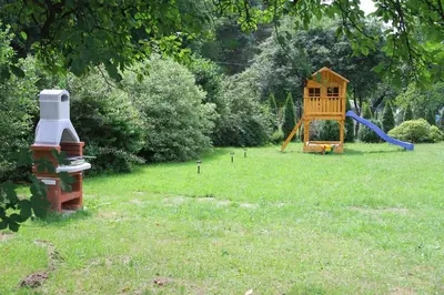 a playground with a slide and a play house at Willa Kryspinów in Kraków