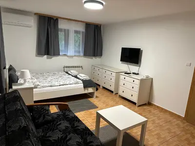 a small bedroom with a bed and a tv at Willa Kryspinów in Kraków