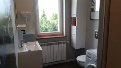 a room with red cabinets and a bed in it at Street Art Apartment in Oświęcim