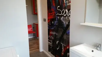 a bathroom with a sink and a mirror at Street Art Apartment in Oświęcim