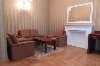 a living room with two chairs and a table and a fireplace at Pokoje Gościnne Pałac w Balicach Instytut Zootechniki PIB in Balice