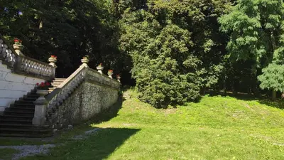 a stone retaining wall with a staircase and trees at Pokoje Gościnne Pałac w Balicach Instytut Zootechniki PIB in Balice