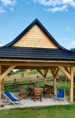 a gazebo with a picnic table and chairs at Domki w górach Na Grapie in Stryszawa