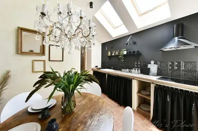 a dining room with a table and a chandelier at Betty's Place in Zabierzów