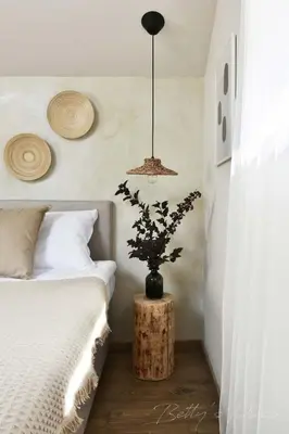 a bedroom with a bed and a plant on a table at Betty's Place in Zabierzów
