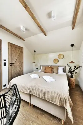 a bedroom with a large bed and a wooden floor at Betty's Place in Zabierzów