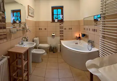 a bathroom with two sinks and a tub and a toilet at Dom Na Wzgórzu 479, The House on the hill in Sułkowice