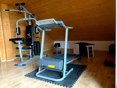 a room with a gym with a treadmill at Dom Na Wzgórzu 479, The House on the hill in Sułkowice
