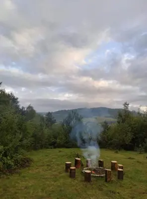 a fire pit in a field with smoke at Dom Na Wzgórzu 479, The House on the hill in Sułkowice