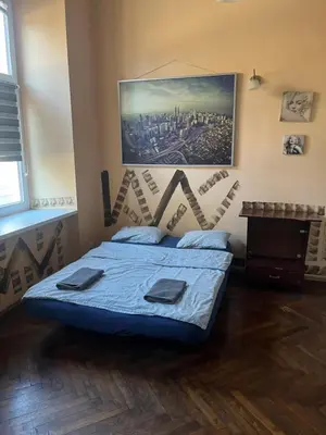a bedroom with a bed with a blue comforter at Adam12 in Kraków