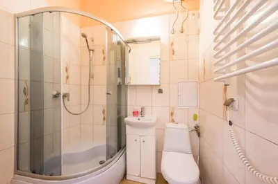 a bathroom with a shower and a toilet and a sink at Adam12 in Kraków