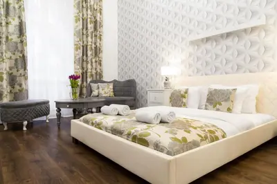 a bedroom with a large white bed and a table at HOUSEHOST Apartment: Bogusławskiego Street in Kraków