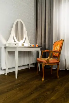 a white dressing table with a chair and a mirror at HOUSEHOST Apartment: Bogusławskiego Street in Kraków