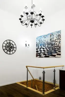 a chandelier and a picture on a wall at HOUSEHOST Apartment: Bogusławskiego Street in Kraków