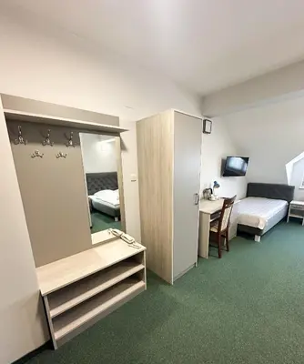 a hotel room with a bed and a mirror at Hotel Arkadia in Klecza Górna