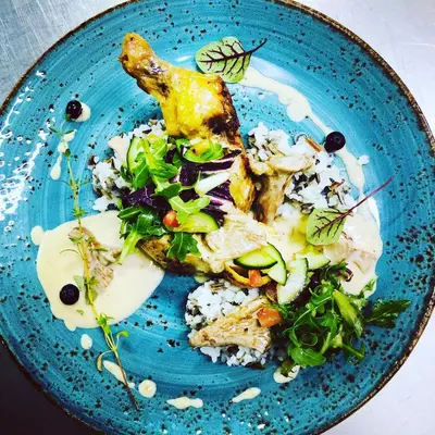 a blue plate of food with rice and vegetables at Hotel Arkadia in Klecza Górna