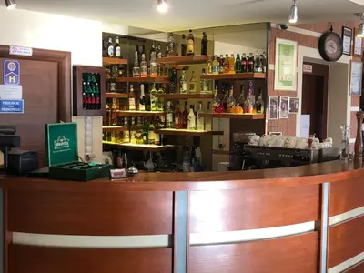 a bar with a wooden counter in a restaurant at Hotel Arkadia in Klecza Górna