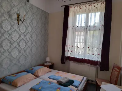 a bedroom with a bed and a window at Kraków Hostel in Kraków