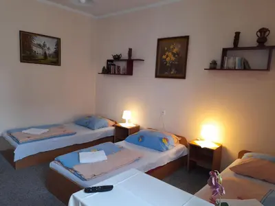 two beds in a room with two tables and two lamps at Kraków Hostel in Kraków