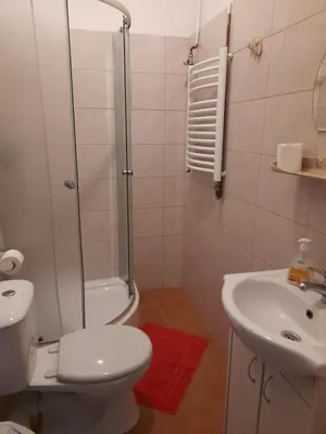 a bathroom with a shower and a toilet and a sink at Kraków Hostel in Kraków