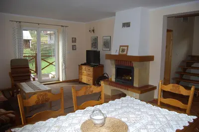 a kitchen and dining room with a table and chairs at Gosidomek in Zawoja
