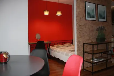 a room with a bed and a table and chairs at Niko Apartments 1 in Kraków