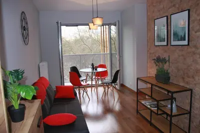 a living room with a couch and a table with chairs at Niko Apartments 1 in Kraków