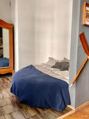 a bedroom with a bed and a mirror in it at Old Town Krakow! Amazing location & character in Kraków
