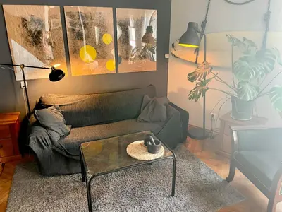 a living room with a couch and a coffee table at Old Town Krakow! Amazing location & character in Kraków