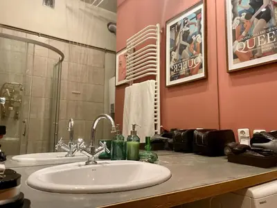 a bathroom with a white sink and a mirror at Old Town Krakow! Amazing location & character in Kraków