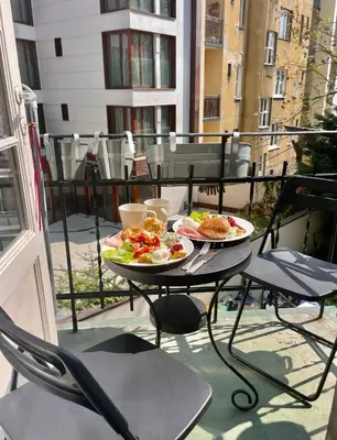 a table with two plates of food on a balcony at Old Town Krakow! Amazing location & character in Kraków