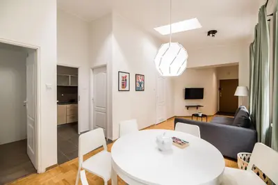 a living room with a white table and a couch at Native Apartments Czysta 5 in Kraków