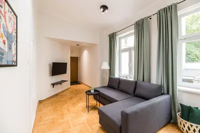 a living room with a couch and a tv at Native Apartments Czysta 5 in Kraków