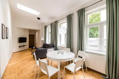 a living room with a table and chairs and a couch at Native Apartments Czysta 5 in Kraków