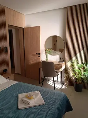 a bedroom with a bed and a desk and a mirror at Apartament Lena Stare Miasto in Kraków