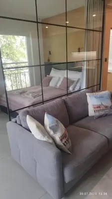 a living room with a couch and two beds at Apartament Lena Stare Miasto in Kraków