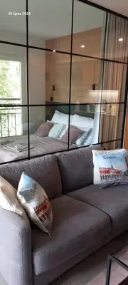 a living room with a couch and two beds at Apartament Lena Stare Miasto in Kraków