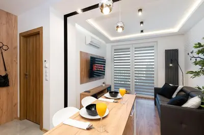 a living room with a table and a couch at Comfort, prestige, best location Romanowicza 1 in Kraków