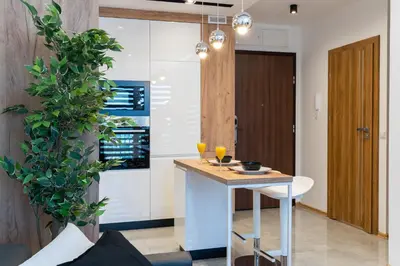 a kitchen with a small table and a plant at Comfort, prestige, best location Romanowicza 1 in Kraków
