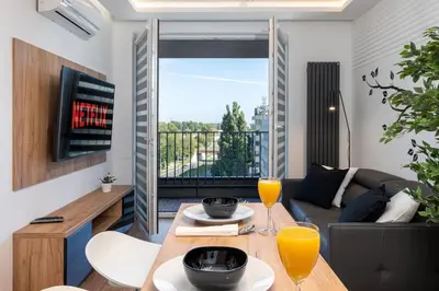 a living room with a table with two glasses of orange juice at Comfort, prestige, best location Romanowicza 1 in Kraków