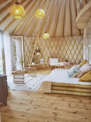 a large room with a bed in a yurt at LushHills - Nowoczesna Jurta in Regulice