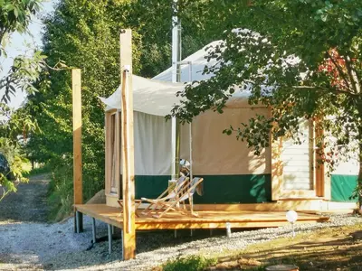 a cabin in a tree with a porch at LushHills - Nowoczesna Jurta in Regulice