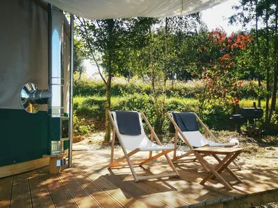 two folding chairs sitting on a patio at LushHills - Nowoczesna Jurta in Regulice