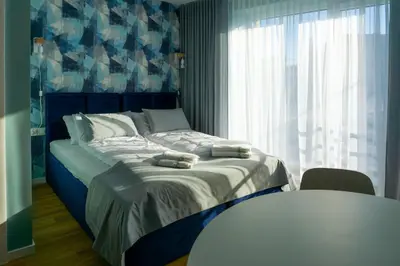 a bedroom with a bed with two towels on it at Trzy Małe Drzewka in Wielka Wieś