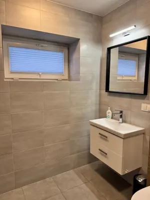 a bathroom with a sink and a mirror at Trzy Małe Drzewka in Wielka Wieś