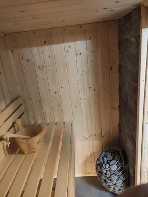 a inside of a sauna with a bucket at Trzy Małe Drzewka in Wielka Wieś