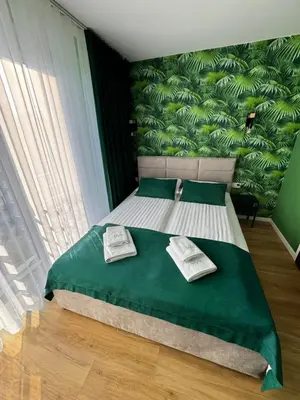 a bedroom with a bed with two towels on it at Trzy Małe Drzewka in Wielka Wieś