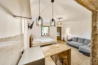 a bathroom with two sinks and a tub and a shower at Apartament Turbacz in Klikuszowa