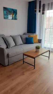 a living room with a couch and a coffee table at APARTAMENT DĄBSKA 24 TAURON ARENA in Kraków